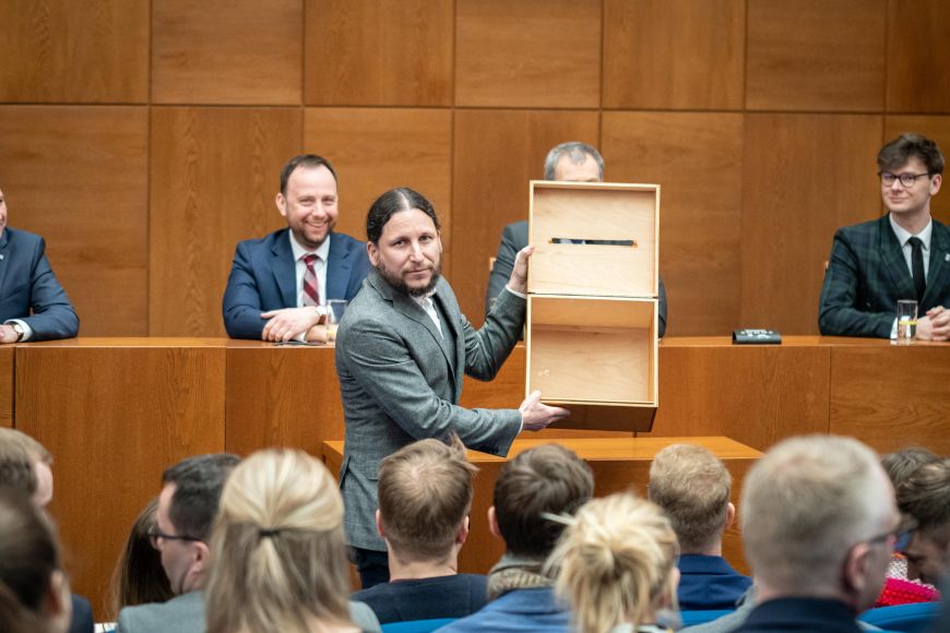 Ivan Foletti, chairman of the MU Academic Senate election committee, shows an empty ballot box.