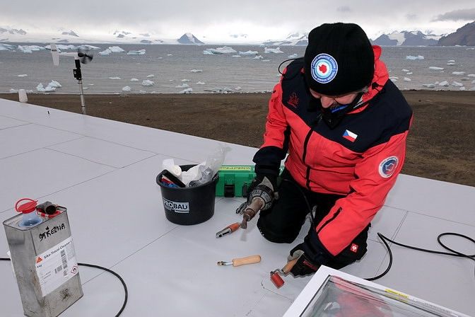 Pokrývač Dimitris Georgiadis pracuje na střeše polární stanice. 