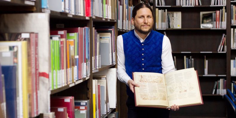 Ivan Foletti, head of the Centre for Early Medieval Studies with one of the gifted books.